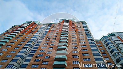 Multi-colored modern multi-storey residential building and multi-apartment panel house with Windows and balconies Stock Photo