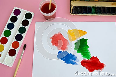 Multi-colored objects for drawing and creativity for children lie on a pink background. Bright watercolor paints, pencils, brushes Stock Photo