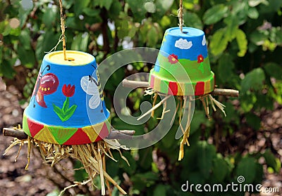 Multi colored painted flower pots filled with straw Stock Photo