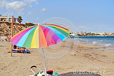 Multi colored parasol on the beach of Mil Palmeras, Spain Stock Photo