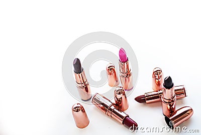Multi-colored pink and dark lipstick isolated on white background Stock Photo