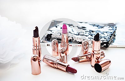 Multi-colored pink and dark lipstick with light coloured background Stock Photo