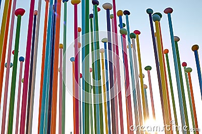 Milan, Italy, March 2020. Multi-colored poles in the form of flower stamens look at the blue sky. Positive bright background. Editorial Stock Photo