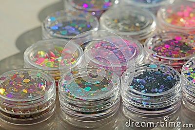 Multi colored Sequins for the design of nails in a Jar. Glitter in jars. Foil for nail service. Photo set. Sparkling beauty Stock Photo