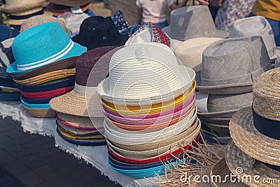 Multi-colored summer hats on the market counter Stock Photo