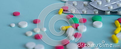 Multi-colored tablets of different shapes and colors. Placer pills and a stack of blisters. Web banner. Medical concept Stock Photo