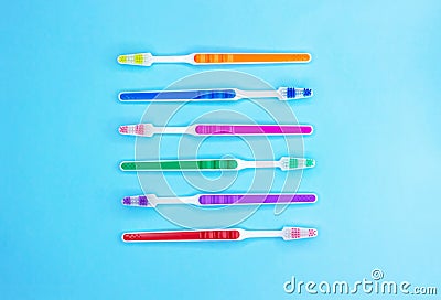 Multi-colored toothbrushes on a blue background Stock Photo