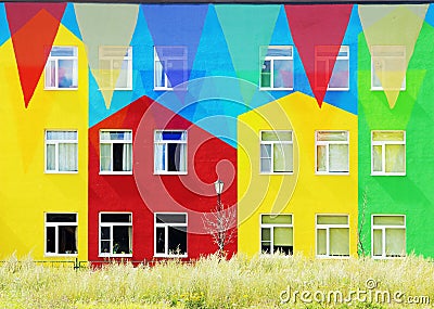 Multi Colored Triangular Flags Hanging against the backdrop of colorful houses. Stock Photo