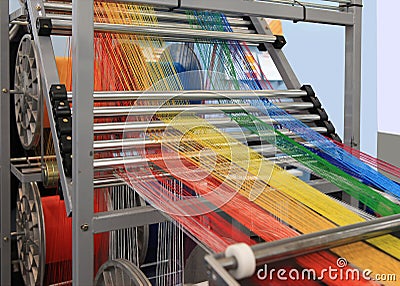 Multi-colored yarns in the textile machine Stock Photo