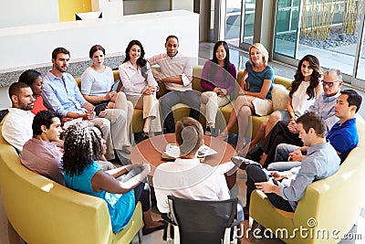 Multi-Cultural Office Staff Sitting Having Meeting Together Stock Photo