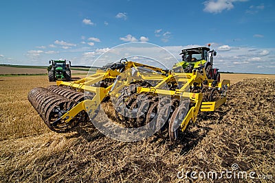 Disc cultivator, tillage system in operation with tractor Stock Photo