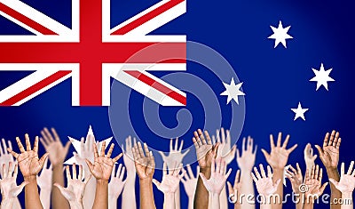 Multi-Ethnic Arms Raised and Australian Flag Background Stock Photo