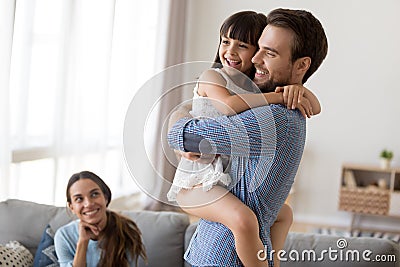 Happy family at home father hold on hands daughter Stock Photo