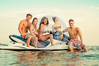 Multi ethnic friends on a jet ski Stock Photo