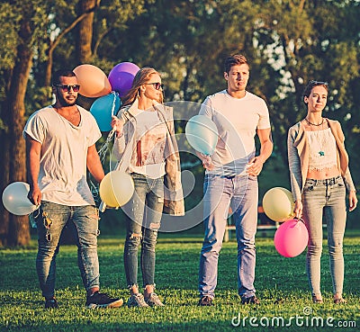 Multi-ethnic group of friends having party in a park Stock Photo