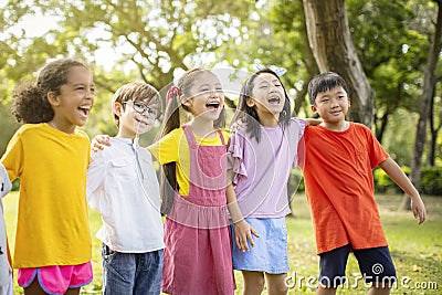 Multiethnic group of school kids laughing and embracing Stock Photo