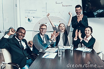 Multi ethnic group of successful business people rejoice at success in conference hall. Stock Photo