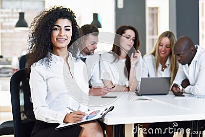 Multi-ethnic group of three businesspeople meeting in a modern o Stock Photo