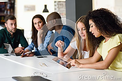 Multi-ethnic group of young people studying with laptop computer Stock Photo