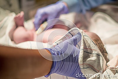 Multi-ethnic newborn baby immediately after being born / childbirth being cared for by nurses and health professionals Stock Photo