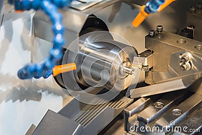 Multi function CNC lathe machine cutting the small part Stock Photo