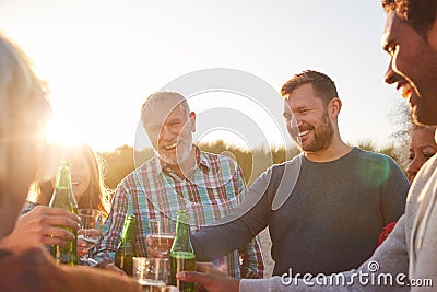 Multi-Generation Adult Family Celebrating With Wine On Winter Beach Vacation Stock Photo