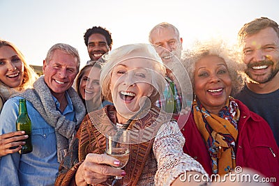 Multi-Generation Adult Family Taking Selfie At Outdoor Party Celebration Stock Photo