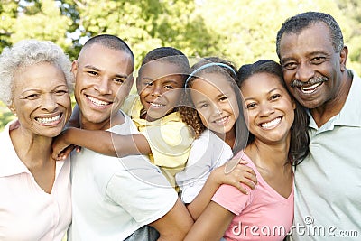 Multi Generation African American Family Relaxing In Park Stock Photo