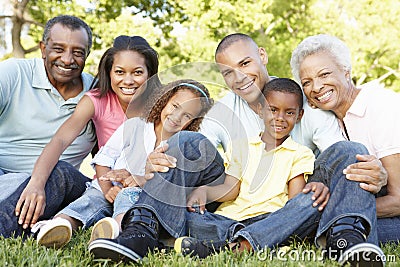 Multi Generation African American Family Relaxing In Park Stock Photo