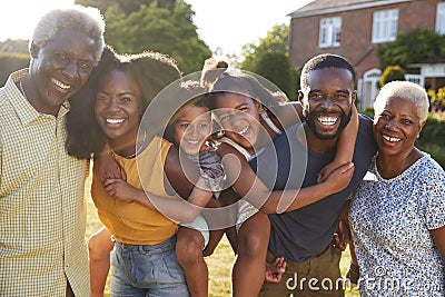 Multi generation black family, parents piggybacking kids Stock Photo