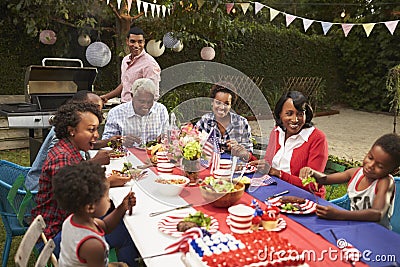 Multi generation black family at table for 4th July barbecue Stock Photo