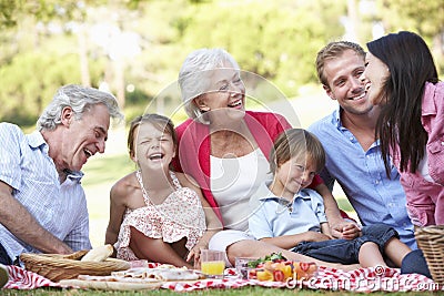 Multi Generation Family Enjoying Picnic Together Stock Photo