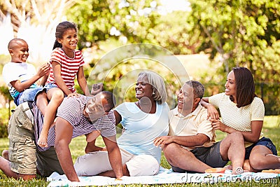 Multi Generation Family Having Fun In Garden Together Stock Photo