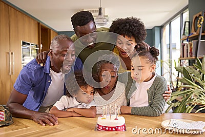 Multi-Generation Family With Military Father Celebrating Birthday With Cake Ay Home Stock Photo