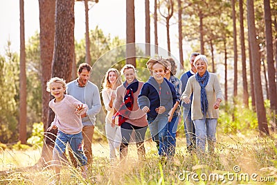 Multi-generation family walking in countryside, kids running Stock Photo