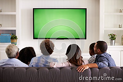 Multi generation family watching TV at home, back view Stock Photo
