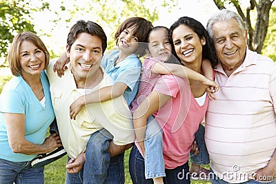 Multi Generation Hispanic Family Standing In Park Stock Photo