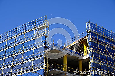 Scaffolding and Blue Safety Cladding on Construction Stock Photo