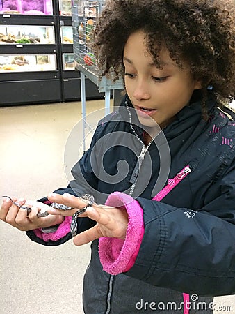 Multi Racial tween girl close up with small snake Stock Photo