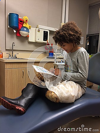 Multi Racial tween girl in dentist chair Stock Photo