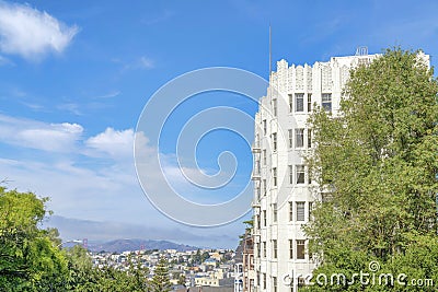 Multi-storey apartment building and a view of San Francisco neighborhood and mountain in California Stock Photo