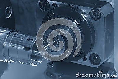 The multi-tasking CNC lathe machine milling the metal tube parts by milling spindle Stock Photo