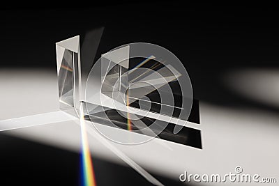 Multi triangular Prism dispersing sun beam splitting into a spectrum on white background Stock Photo