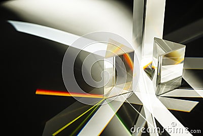 Multi triangular Prism dispersing sun beam splitting into a spectrum on white background Stock Photo