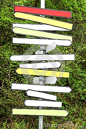 Multicolor blank signpost arrows in the forest Stock Photo