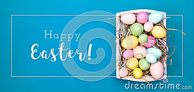 Multicolor eggs in a white tray. Creative Easter concept. Modern solid turquoise background. Stock Photo