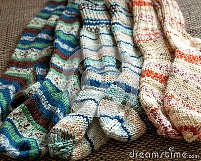 multicolor hand knitted different sizes and different colors warm winter wool knitted sock,s waiting for winter Stock Photo