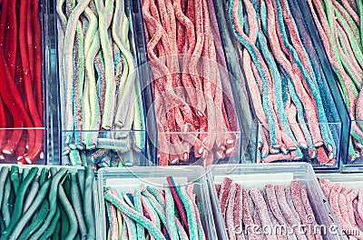 Multicolor tasty licorice candies in plastic containers Stock Photo
