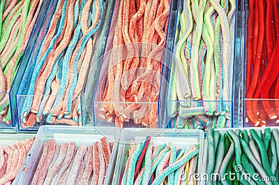 Multicolor tasty licorice candies in plastic containers Stock Photo