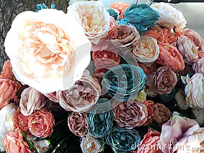 Multicolored artificial flowers bouquet on the street Stock Photo